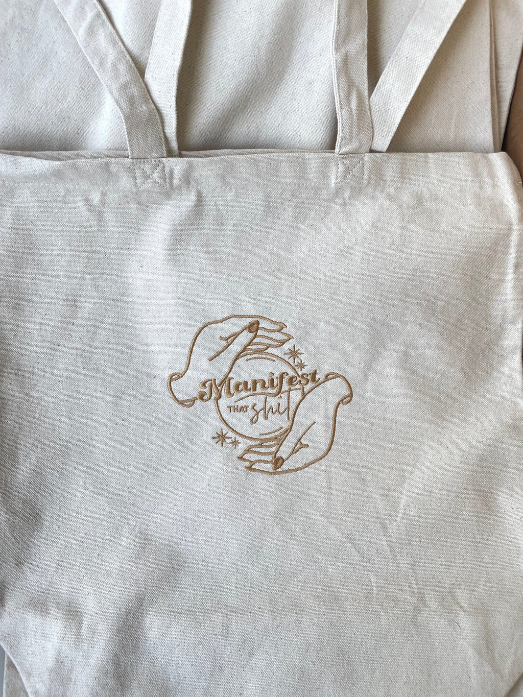 Manifest that shit tote bag